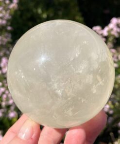 large calcite sphere in pale yellow or pale golden colour