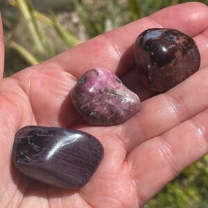 polished sugilite crystal with bustamite